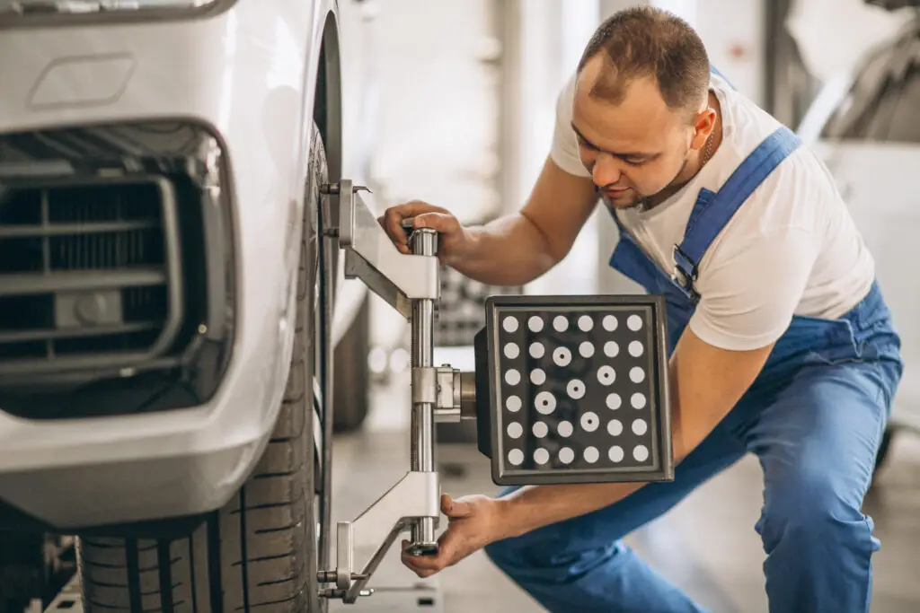 Auto mechanic checking car